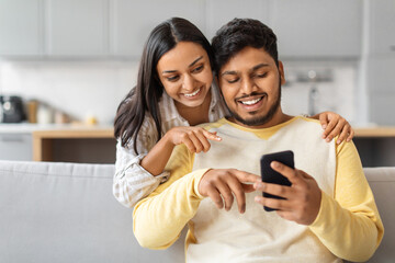 Indian Man and Woman Looking at Cell Phone