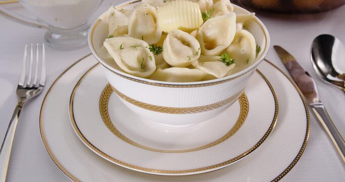 Dumplings in a plate with butter on the table, Uzbek Chuchvara - option 5