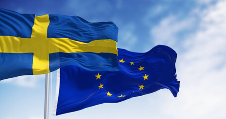 Sweden and the European Union flags waving together on a clear day - 774285781