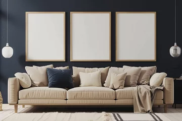 Foto op Canvas A serene Scandinavian living room featuring a beige sofa against a dark navy wall. Three blank mock-up poster frames in a light oak finish provide a warm and natural contrast above the sofa. The sp © Usama