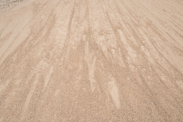 Fine river sand from gravel pit pile closeup as beige sand natural background