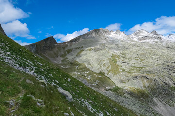 Idyllic hiking trail with panoramic view of majestic mountain peak Woisgenkopf, High Tauern...