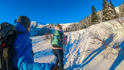 Couple in snowshoes on snow covered mountains of Kor Alps, Lavanttal Alps, Carinthia Styria,...