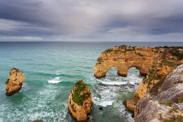 Papier Peint photo Plage de Marinha, Algarve, Portugal Landscape on the Algarve coast at sunset. Beach in southern Portugal the best travel destination for tourists on vacation. seascape with caves through the cliffs