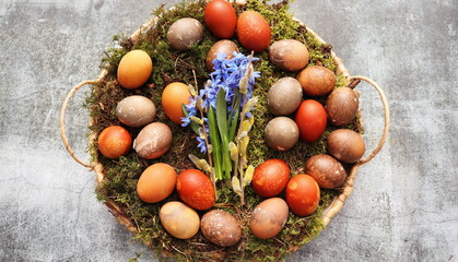 Stylish Easter table setting. Natural egg on wicker tray. Easter table decoration