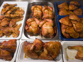 various parts of chicken meat cooked on the grill