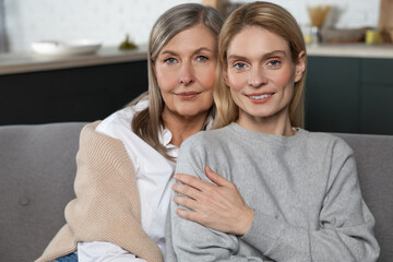 Mature woman with her adult daughter enjoying warm communication