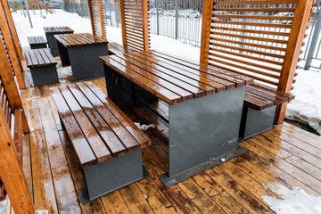 Wooden table and benches on deck made of hardwood planks