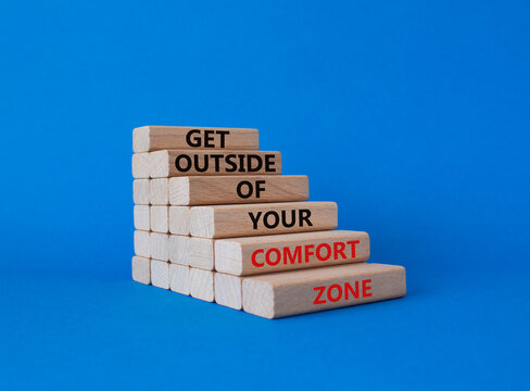 Get outside of your comfort zone symbol. Concept words Get outside of your comfort zone on wooden blocks. Beautiful blue background. Business concept. Copy space.