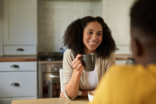 Smiling African woman talking with her husband over coffee at breakfast - Powered by Adobe