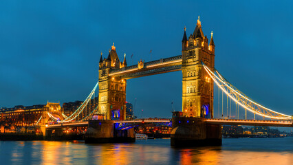 Tower Bridge illuminated at dusk, London, England.