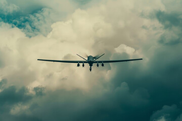 Fototapeta na wymiar A military drone flies through a cloudy sky
