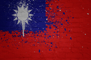 colorful painted national flag of taiwan on a massive old brick wall