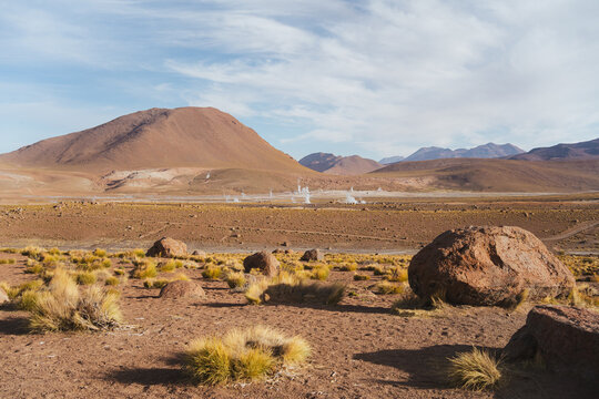 Dry landscape shot of field full of geysers. El Tatio geysers in Atacama desert, Chile.