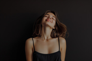Naklejka premium Minimalistic composition akin to modern fashion photography, a 19-year-old exuding confidence and joy against a sleek solid black background