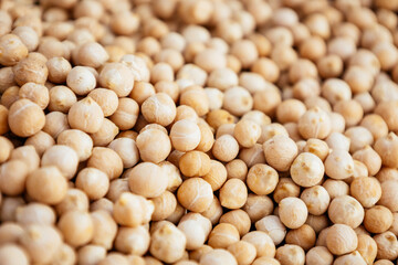 Uncooked dried legume chickpeas or garbanzo bean as background. Vegetarian super food. Healthy eating and dietary. Indian, Mediterranean and Middle Eastern cuisine.