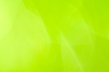 Abstract bright light green blurred background, spring background with sun glare