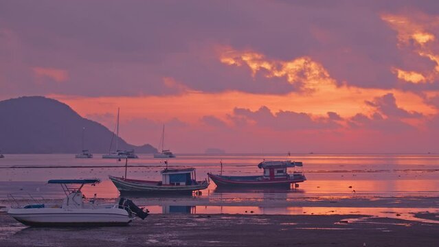 The scene of a cloud in the beautiful sky atop the fishing boats at sunrise is absolutely breathtaking. create a stunning backdrop for the colorful fishing boats bobbing in the crystal-clear below.