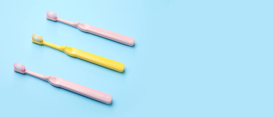 Plastic toothbrushes on blue background