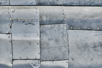 Metal texture. Background from riveted different aluminum plates