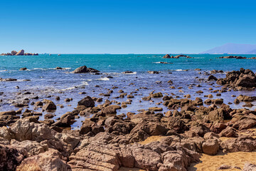 Fototapeta na wymiar View of the rocky shore of the South China Sea in the World's End Park. Sanya, China