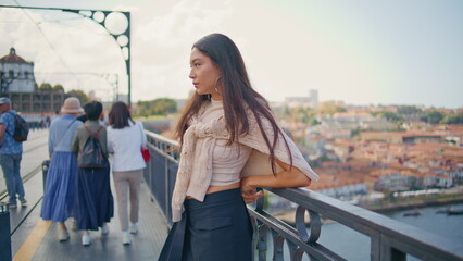 Thoughtful girl watching city views at bridge closeup. Sad woman looking away