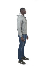 side view portrait of an african man standing on white background