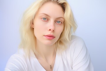 Naklejka premium Pretty Blonde Woman with Blue Eyes and White Shirt. Generative AI.