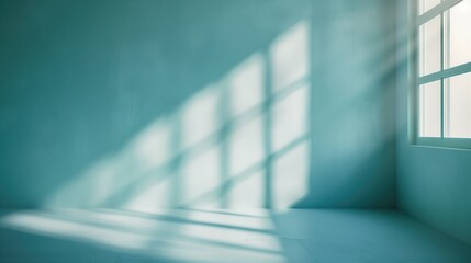 Minimal abstract light blue background for product presentation. Shadow and light from windows on plaster wall.