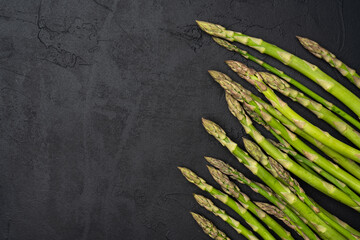 Fresh green asparagus on the black  background
