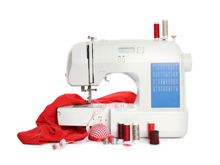 Modern sewing machine with red cloth and craft accessories isolated on white