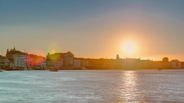 Sunrise at Grand canal over San Marco square timelapse. View from Church of Santa Maria della Salute, Venice, Italy, European Union. Famous historical heritage. Reflection on water