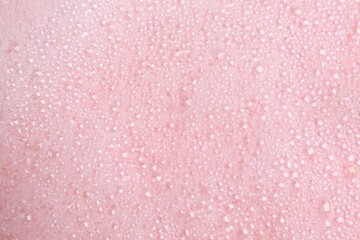 White fluffy foam on pink background, top view