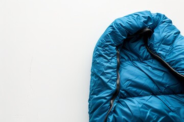 Close up of sleeping bag on white background for National Camping Month