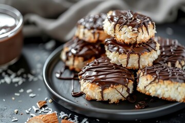Coconut cookies with chocolate served on a black plate