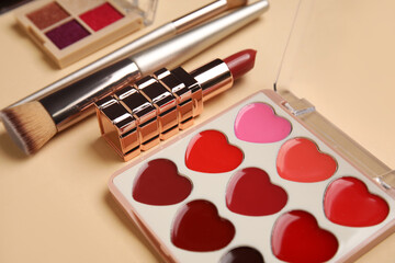 Lipstick, brush and heart-shaped palette of tint