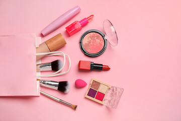 Set of cosmetic products in shopping bag on pink background. Top view