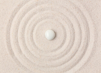 Fototapeta na wymiar Stone on sand with lines in Japanese rock garden, top view. Zen concept