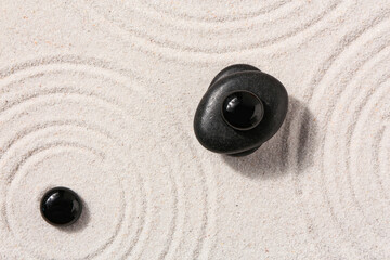 Stones on sand with lines in Japanese rock garden. Zen concept