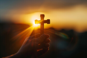 Christian Cross in Hand During Sunset Background