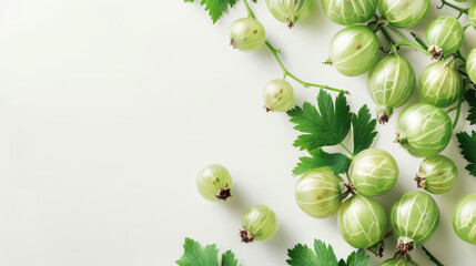 Ripe gooseberry cluster with leaves against a painted surface.
