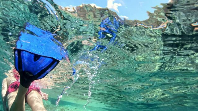 Snorkeler explores the vibrant underwater world at Saint Andrew beach on Elba island, with crystal-clear visibility. The Tuscan archipelago gracing the Mediterranean waters off Italy's coast.