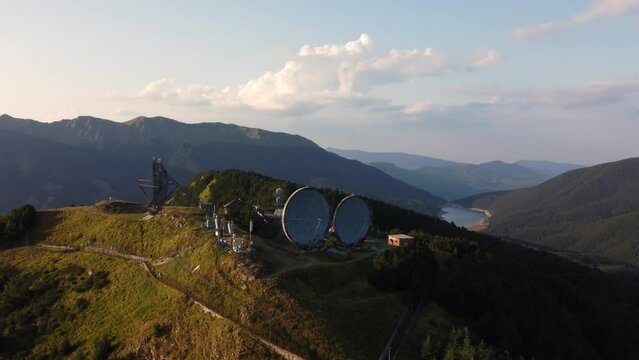 Aerial view of the big parabolic antenna of the NATO radio station abandoned on the top of Monte Giogo, used during cold war. Comano, Massa and Carrara province, Lagastrello lake, Tuscany, Italy. 