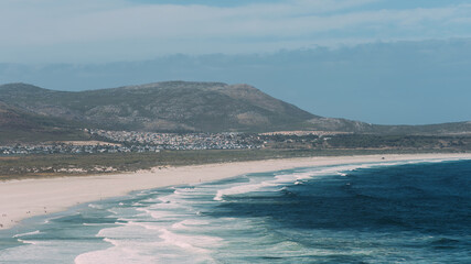 Serene Noordhoek Beach in South Africa With Pristine White Sands and Gentle Waves at Dusk