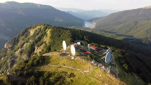 Aerial view of the big parabolic antenna of the NATO radio station abandoned on the top of Monte Giogo, used during cold war. Comano, Massa and Carrara province, Lagastrello lake, Tuscany, Italy. 