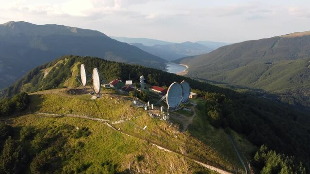 Aerial view of the big parabolic antenna of the NATO radio station abandoned on the top of Monte Giogo, used during cold war. Comano, Massa and Carrara province, Lagastrello lake, Tuscany, Italy. 