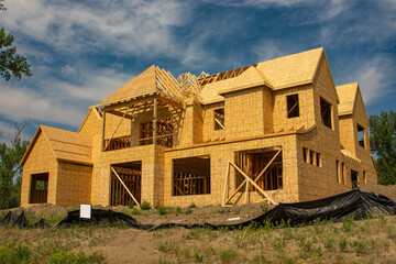 Large upscale two story wood frame home  under construction.
