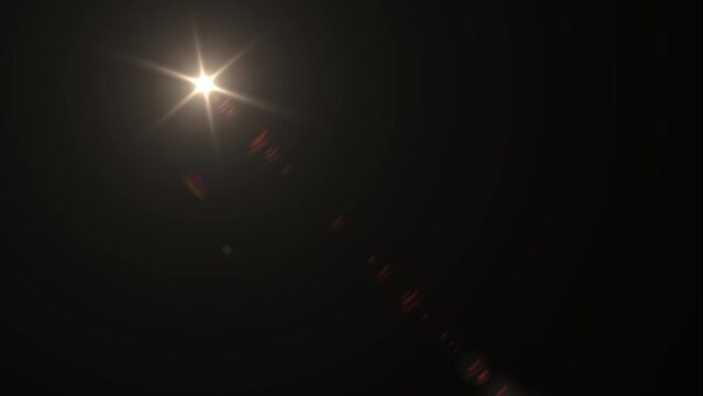 Optical Lens flare effect on black background. Movement of the sun across the sky. Anamorphic lens effect in yellow tone, 4K video. Overlay light effect animation.