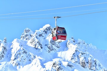 Vintage ski lift over the ski slopes of French alps. - obrazy, fototapety, plakaty