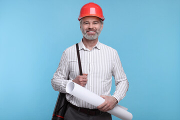 Architect in hard hat holding draft on light blue background
